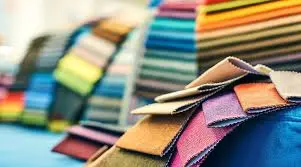 A collection of colorful webbing rolls used for garment accessories.