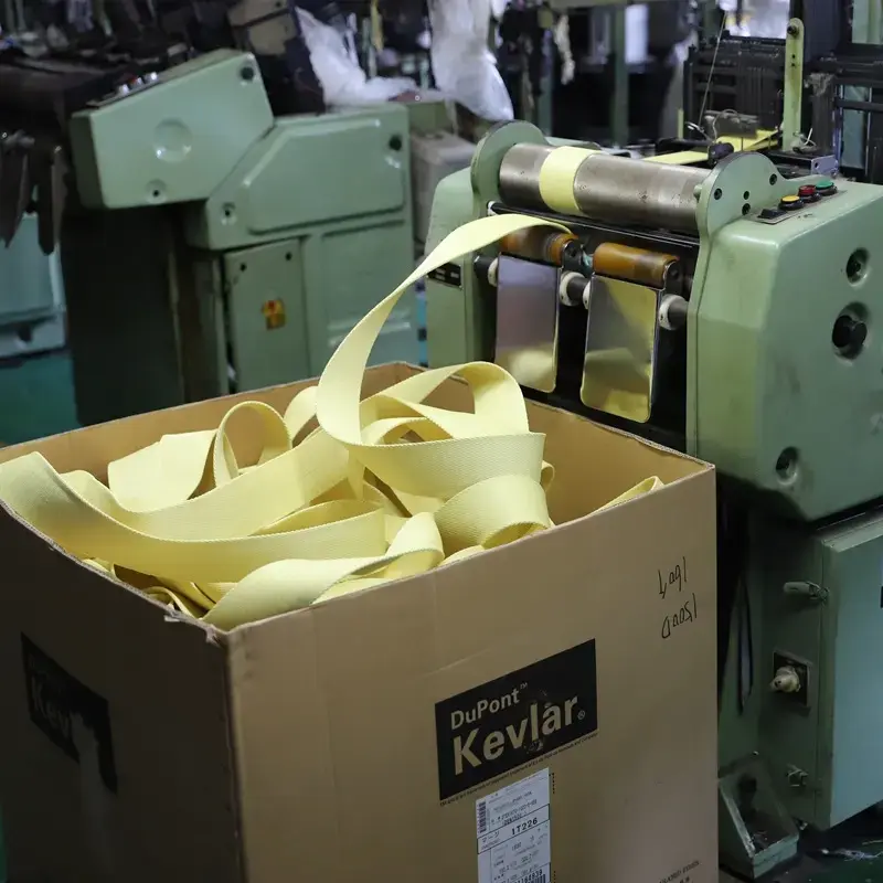 Rolls of yellow KEVLAR aramid webbing, known for its flame retardant and bulletproof properties.
