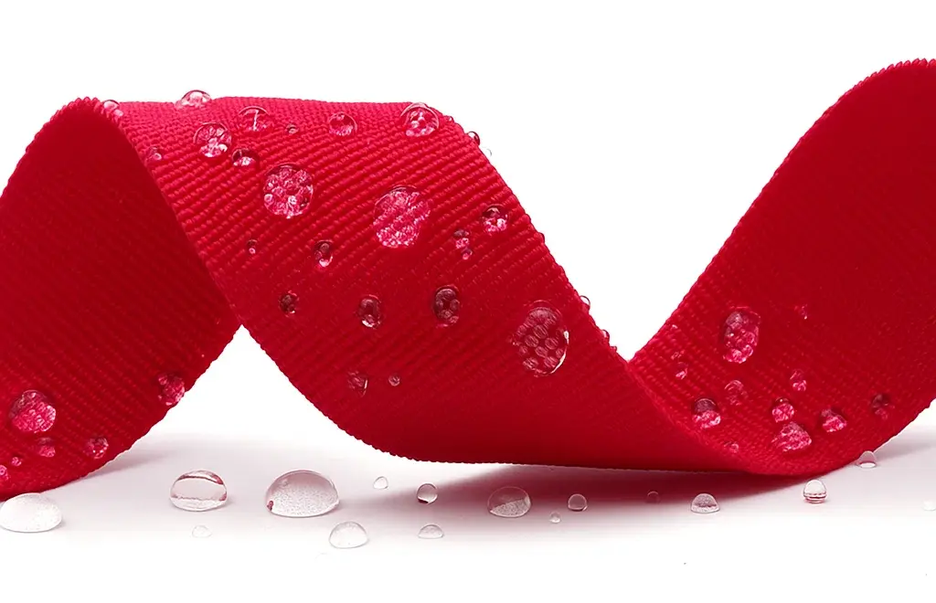 Demonstrating the water repellency of the polypropylene webbing.