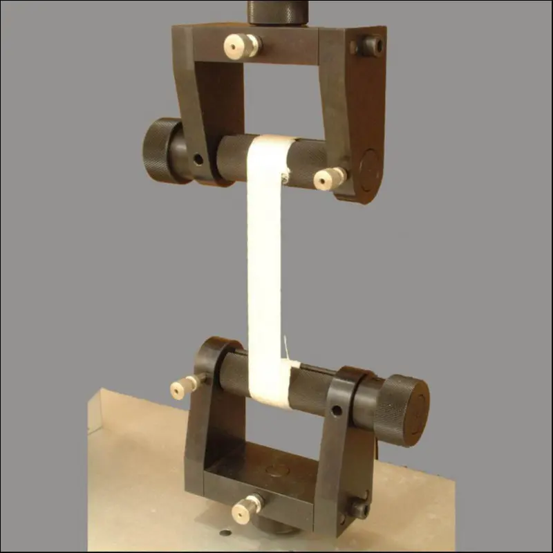 Webbing undergoing a tensile strength test on a professional machine, a key part of quality control.