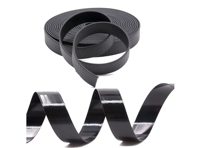 A flexible, matte-finish TPU coated webbing is bent next to a glossier, stiffer PVC coated webbing, highlighting their differences.